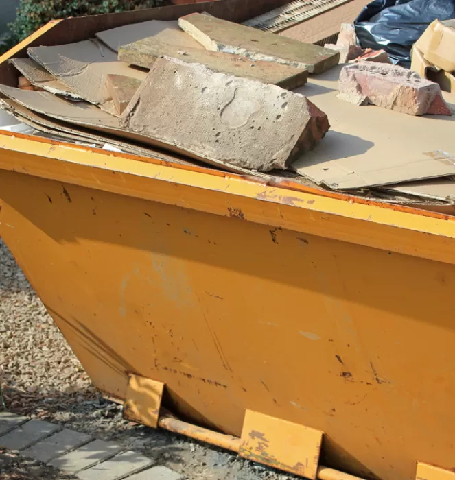 yellow skip with debris in