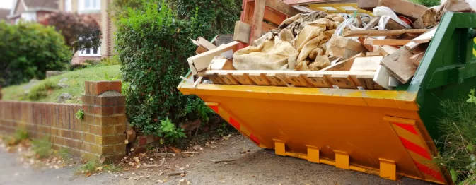 yellow and green skip on driveway