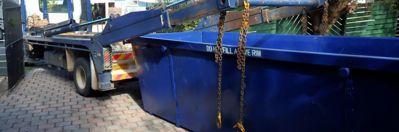blue skip being dropped off in Manchester