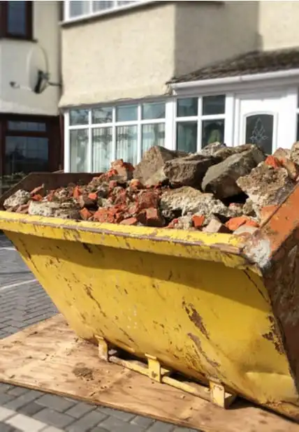 skip with rubble on a driveway