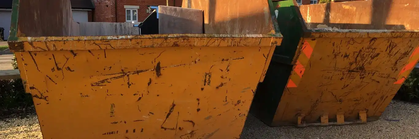 two skips on a driveway